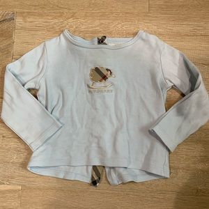 Burberry long sleeve shirt. Button clasps in the back. Light blue color